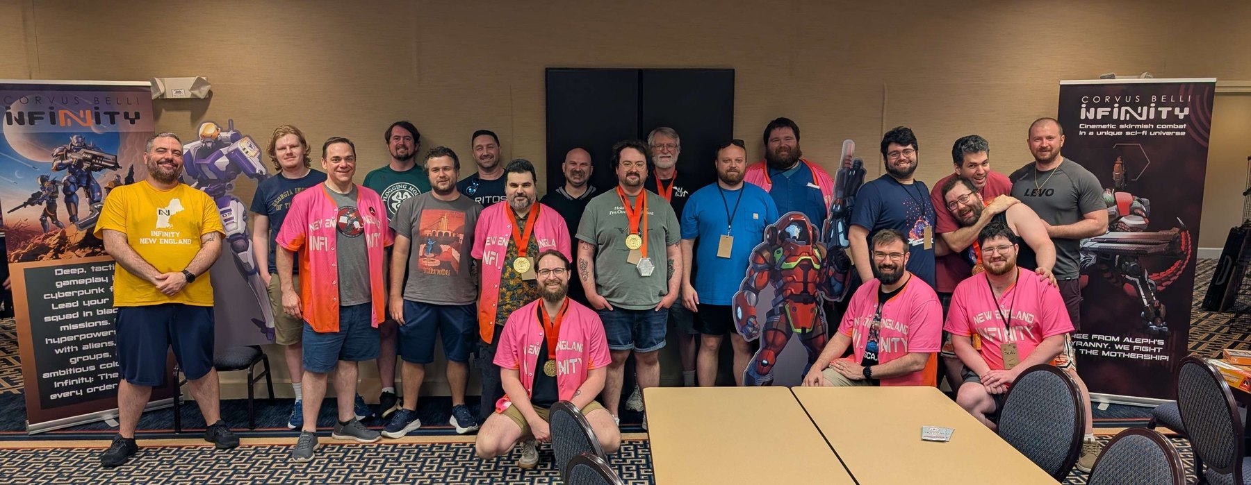 Bay State Showdown 2026 competitors gathered for a group photo, medalists wearing their medals, at the Ironweld Gaming Convention in Wakefield, MA